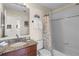 Bathroom with granite counter, wood vanity, shower-tub combination with themed shower curtain at 123 52Nd St # B, Bradenton Beach, FL 34217