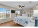 Bright bedroom features a sliding glass door, hardwood floors and a ceiling fan at 123 52Nd St # B, Bradenton Beach, FL 34217