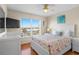 Bright bedroom featuring a ceiling fan, hardwood floors, and a window with a view at 123 52Nd St # B, Bradenton Beach, FL 34217