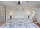Bright bedroom with hardwood floors, adjacent bath, ceiling fan, and comfortable bed at 123 52Nd St # B, Bradenton Beach, FL 34217