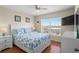 Well lit bedroom featuring hardwood floors, ceiling fan and a TV set on the wall at 123 52Nd St # B, Bradenton Beach, FL 34217