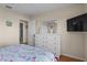 Comfortable bedroom with a TV, dresser, hardwood floors and a partial view to en-suite at 123 52Nd St # B, Bradenton Beach, FL 34217