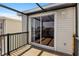 View of wood deck with sliding glass door to home and metal rails and cover at 123 52Nd St # B, Bradenton Beach, FL 34217