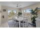 Bright dining area with white table set, coastal decor, and sliding door access to the outside at 123 52Nd St # B, Bradenton Beach, FL 34217