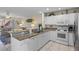 Open kitchen overlooking living area, featuring granite countertops, and white cabinets at 123 52Nd St # B, Bradenton Beach, FL 34217
