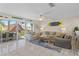Open-concept living room with comfortable seating and access to screened porch at 123 52Nd St # B, Bradenton Beach, FL 34217