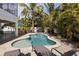Private backyard pool and patio area, surrounded by palm trees and lush landscaping at 123 52Nd St # B, Bradenton Beach, FL 34217