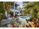 Secluded backyard pool area surrounded by lush landscaping and outdoor seating at 123 52Nd St # B, Bradenton Beach, FL 34217