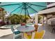 Outdoor dining area with a colorful table setting, pool and spa, perfect for relaxing and entertaining at 123 52Nd St # B, Bradenton Beach, FL 34217