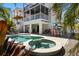 Inviting backyard featuring a sparkling pool, spa, and outdoor dining area, perfect for entertaining at 123 52Nd St # B, Bradenton Beach, FL 34217