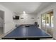 The recreation room features a ping pong table and access to the outdoor patio at 123 52Nd St # B, Bradenton Beach, FL 34217