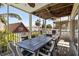 Outdoor dining on screened in porch featuring an outdoor table and chairs with palm tree views at 123 52Nd St # B, Bradenton Beach, FL 34217