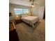 Comfortable bedroom with carpet floors, ceiling fan and natural light coming from the window at 134 Gulfview Rd, Punta Gorda, FL 33950