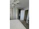 This bedroom includes neutral walls, carpet floors, a ceiling fan and shuttered closet doors at 134 Gulfview Rd, Punta Gorda, FL 33950