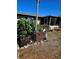 Florida home featuring tropical landscaping, a screened porch, and unique decor at 134 Gulfview Rd, Punta Gorda, FL 33950