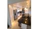 Bright kitchen features white cabinetry, stainless appliances, dark counters, and an island with pendant lighting at 134 Gulfview Rd, Punta Gorda, FL 33950