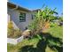 Banana trees and attractive landscaping adorn the home's exterior at 134 Gulfview Rd, Punta Gorda, FL 33950