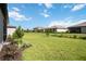 Expansive backyard featuring lush green grass and landscaping with nearby homes at 15127 Oxford Grey Dr, Bradenton, FL 34211