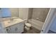 Modern bathroom featuring a sleek vanity, tiled bathtub/shower combo, and stylish flooring at 15127 Oxford Grey Dr, Bradenton, FL 34211