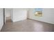 Empty bedroom with wood-look tile flooring and a view of the outside at 15127 Oxford Grey Dr, Bradenton, FL 34211