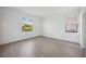 Bright, empty bedroom with wood-look tile flooring and windows offering natural light at 15127 Oxford Grey Dr, Bradenton, FL 34211