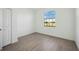Bedroom featuring hardwood flooring, a window and white walls at 15127 Oxford Grey Dr, Bradenton, FL 34211