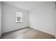 Clean and bright bedroom featuring wood-look tile floor, window, and white trim at 15127 Oxford Grey Dr, Bradenton, FL 34211
