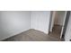 Empty bedroom with wood-look flooring, closet, and neutral wall color at 15127 Oxford Grey Dr, Bradenton, FL 34211