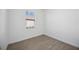This is a bedroom with light wood floors and a bright window with blinds at 15127 Oxford Grey Dr, Bradenton, FL 34211