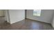 Bright bedroom with hardwood floors and a window overlooking the backyard at 15127 Oxford Grey Dr, Bradenton, FL 34211