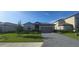 Charming one-story home featuring a manicured lawn, brick driveway, and two car garage at 15127 Oxford Grey Dr, Bradenton, FL 34211
