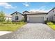 Beautiful single-Gathering home featuring a two-car garage, lovely landscaping, and a brick-paved driveway at 15127 Oxford Grey Dr, Bradenton, FL 34211