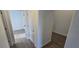 Hallway with gray wood-look flooring and white trim at 15127 Oxford Grey Dr, Bradenton, FL 34211