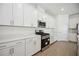 Modern kitchen features stainless steel appliances, sleek white cabinets, and stylish countertops at 15127 Oxford Grey Dr, Bradenton, FL 34211