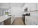 Modern kitchen features an island, stainless steel appliances, and stylish countertops at 15127 Oxford Grey Dr, Bradenton, FL 34211