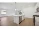Open kitchen with a center island, stainless steel appliances, and a view of the backyard at 15127 Oxford Grey Dr, Bradenton, FL 34211