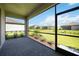 Screened-in lanai with brick pavers overlooking a grassy yard and neighboring homes at 15127 Oxford Grey Dr, Bradenton, FL 34211