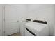 Bright laundry room with white washer and dryer and wire rack shelving at 15127 Oxford Grey Dr, Bradenton, FL 34211