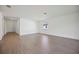Bright and open living space with wood-look tile floors and white walls, providing a modern and airy atmosphere at 15127 Oxford Grey Dr, Bradenton, FL 34211