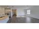 Open living area with hardwood floors, and a modern kitchen with stainless steel appliances at 15127 Oxford Grey Dr, Bradenton, FL 34211