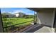 Relaxing screened-in patio with stylish pavers and a serene view of the lush green lawn and manicured landscaping at 15127 Oxford Grey Dr, Bradenton, FL 34211