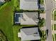 Aerial view of a home with a private screened-in pool and a well-manicured lawn at 17737 Savory Mist Cir, Bradenton, FL 34211