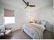 Cozy bedroom features natural light, hardwood floors, ceiling fan and neutral decor at 17737 Savory Mist Cir, Bradenton, FL 34211