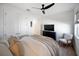 Well lit bedroom with hardwood floors, ceiling fan and seating area at 17737 Savory Mist Cir, Bradenton, FL 34211