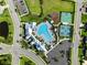 Aerial view of a community pool area with many chairs, playground, and sports courts at 17737 Savory Mist Cir, Bradenton, FL 34211