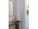 Stylish entryway table with decorative items, a mirror, and modern decor at 17737 Savory Mist Cir, Bradenton, FL 34211