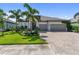 Beautiful single-story home featuring a well manicured lawn, lovely landscaping and two-car garage at 17737 Savory Mist Cir, Bradenton, FL 34211