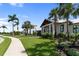 Well-manicured community with lush landscaping and sidewalks leading to modern, light-colored homes at 17737 Savory Mist Cir, Bradenton, FL 34211