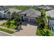 An aerial view of this lovely home with well-manicured landscaping, a paver driveway, and a three-car garage at 17737 Savory Mist Cir, Bradenton, FL 34211
