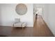 Hallway featuring neutral decor, a modern chair, light wood flooring, and lots of light at 17737 Savory Mist Cir, Bradenton, FL 34211